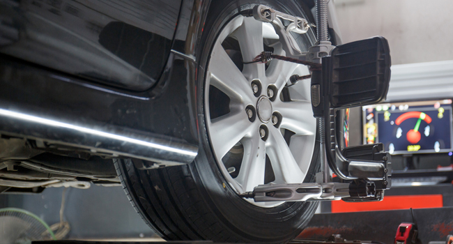 Service Offer - Alignment Special Front passenger tire being aligned using machine