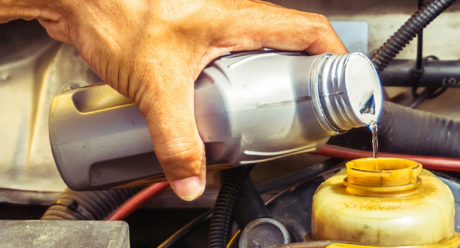 Service Offer - Brake Fluid Flush Special Closeup of hand replacing brake fluid