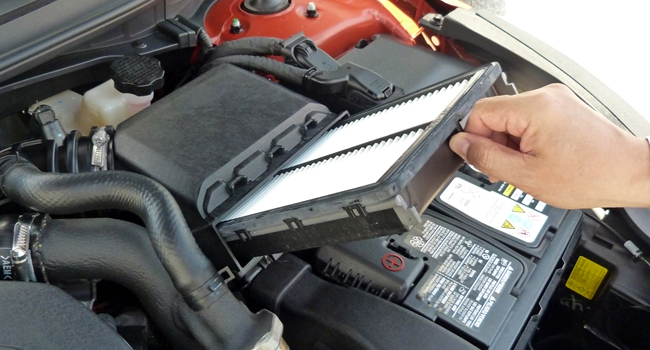 Service Offer - Filter Special Closeup of hand replacing engine filter
