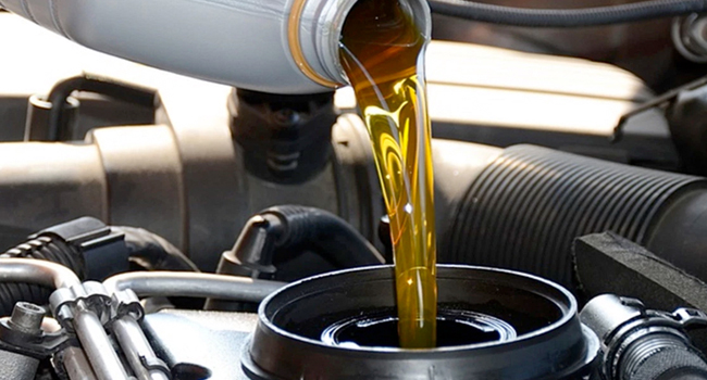 Service Offer - Oil Change Special Oil being poured into engine