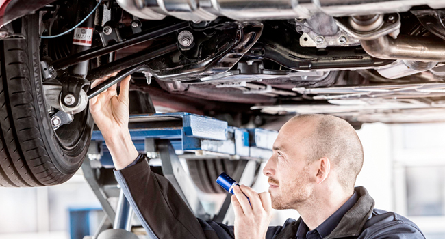 Service Offer - Multipoint Inspection Mechanic inspecting car under a lift