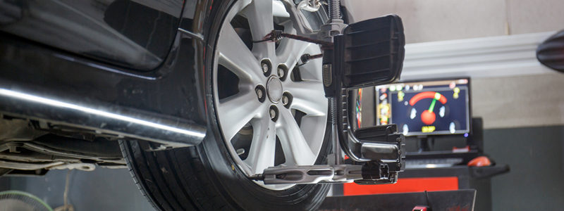 Winter Special Car on a lift with tire being aligned