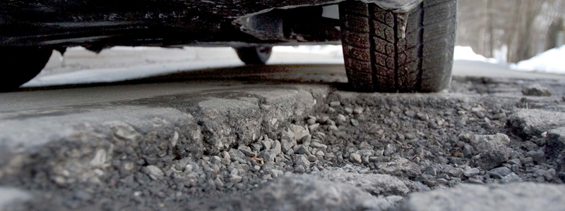 Pothole Special Vehicle Driving Over A Pothole