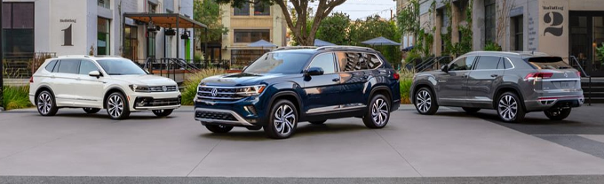 Three Volkswagens parked next to each other
