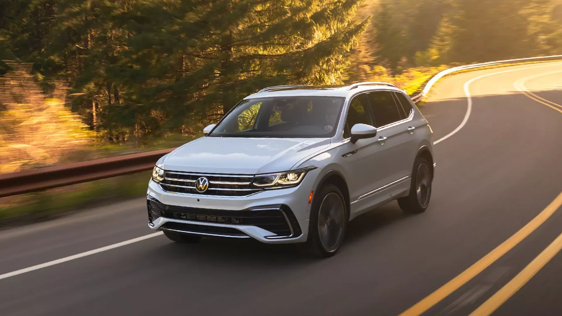 2024 VW Tiguan driving on a wooded road