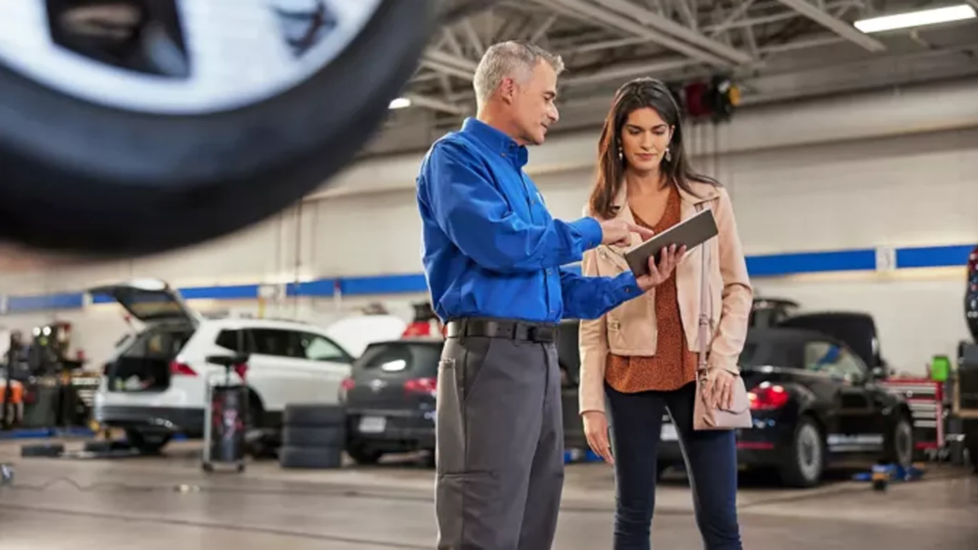 VW service tech talking to a customer